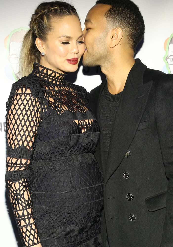 Chrissy Teigen and John Legend share an affectionate moment on the red carpet