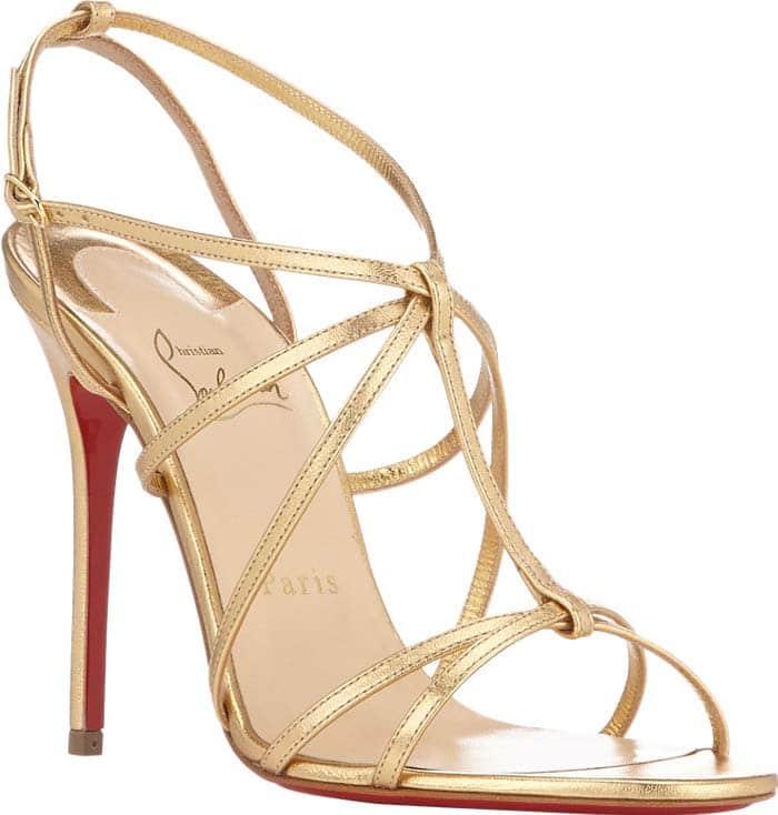 Christian Louboutin’s “Youpiyou” sandals in gold showcase the iconic red sole and intricate strappy design that defines modern evening minimalism