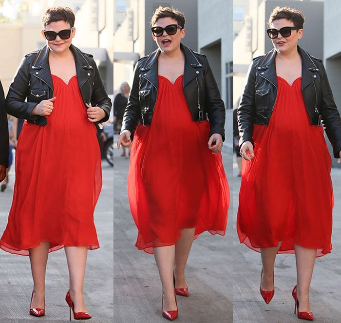 Ginnifer Goodwin creates a striking look by pairing her flowing red dress with matching glossy pumps, contrasted perfectly by a cropped black leather jacket