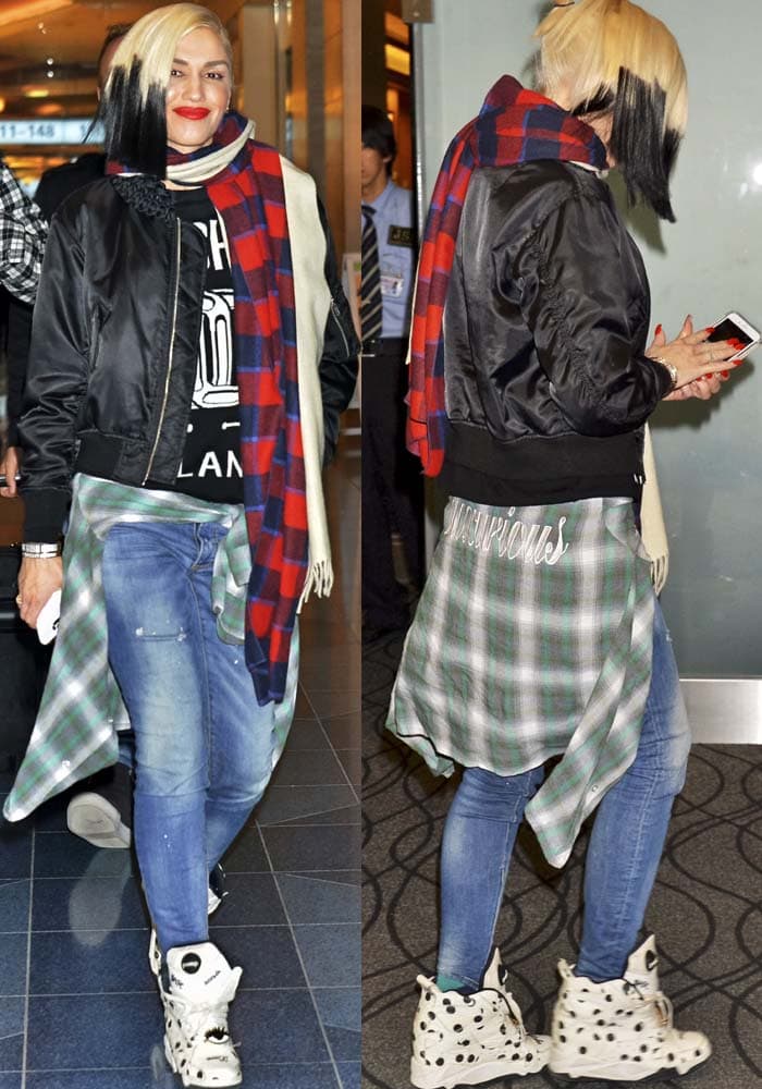Gwen Stefani puts her signature street-spin on airport style in polka-dot hidden-wedge sneakers, grounding her layered bomber, plaid scarf, and skinny jeans with playful, statement-making lift