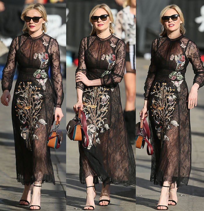 Kirsten Dunst steps out in a sheer black embroidered lace dress, pairing the romantic silhouette with minimalist black ankle-strap sandals that add understated height while keeping the focus on the intricate floral detailing