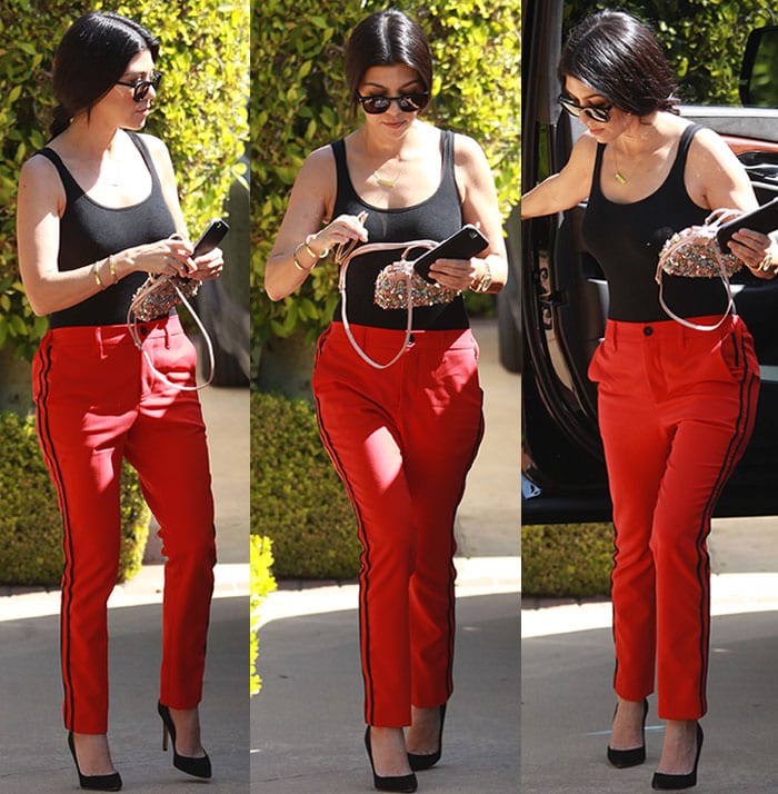 Kourtney Kardashian wears a Wolford top and Zadig Voltaire pants