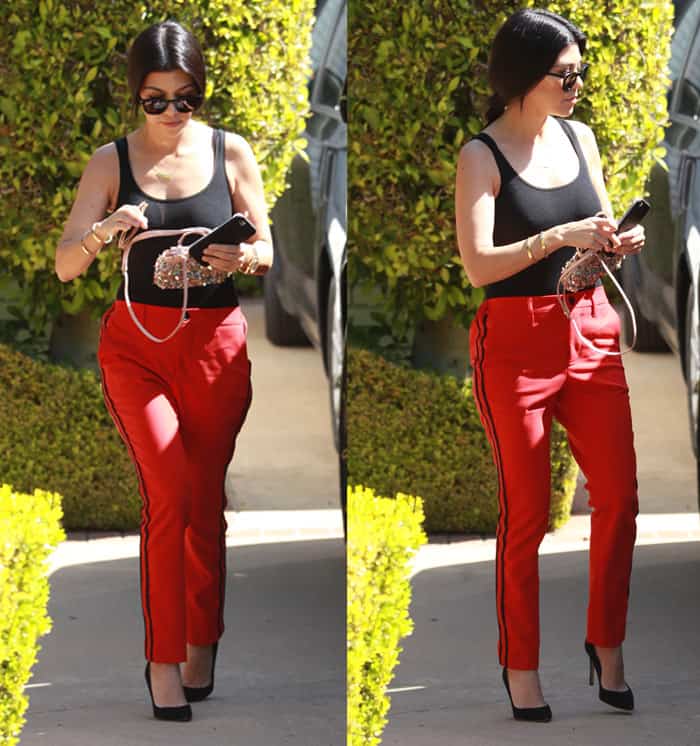 Kourtney Kardashian styled her red track pants with a black tank top