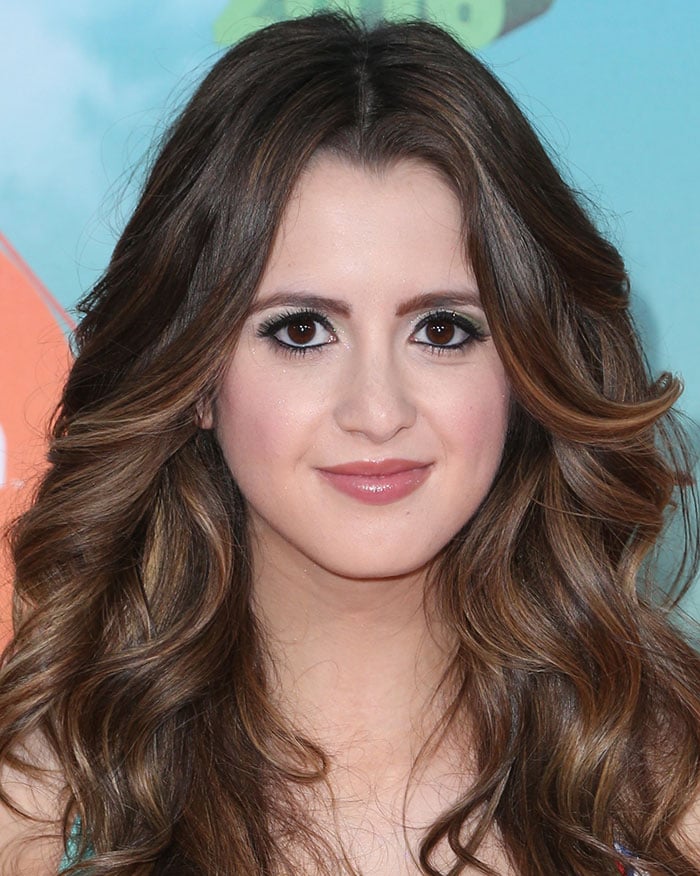 Laura Marano attends the 2016 Kids' Choice Awards, showcasing her voluminous wavy hair and flawless makeup with bold eyeliner and soft pink lips