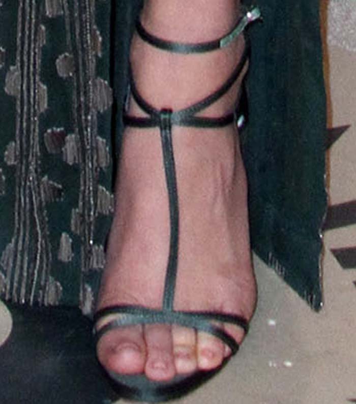A close-up of Olivia Munn’s Christian Louboutin “Youpiyou” sandals highlights the delicate cage straps and barely-there design in matching green satin