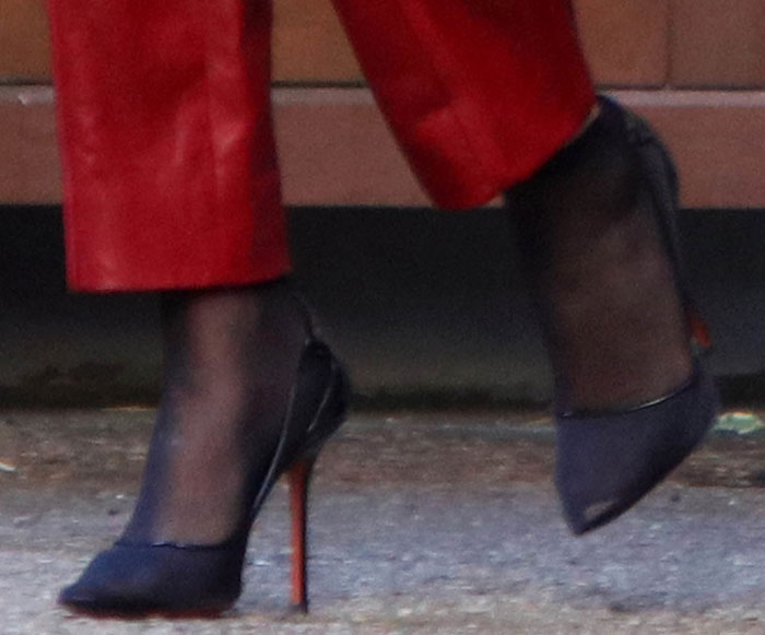 Selena Gomez's Soebedar “Shania” pumps paired sheer mesh panels with glossy patent-leather trim, creating a modern contrast against her bold red Louis Vuitton trousers