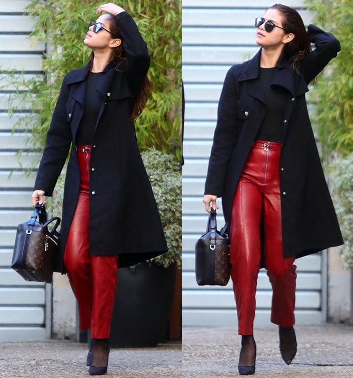Leaving a Paris photo studio during Fashion Week, Selena Gomez combined minimalist black separates with statement-making Louis Vuitton leather pants