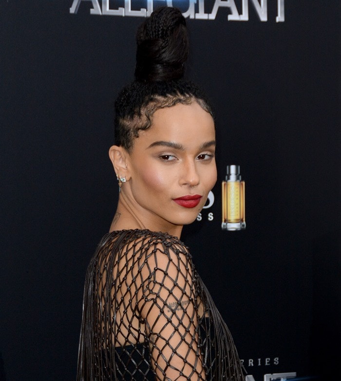 Zoë Kravitz shows off her tattoos through her black Valentino fishnet dress