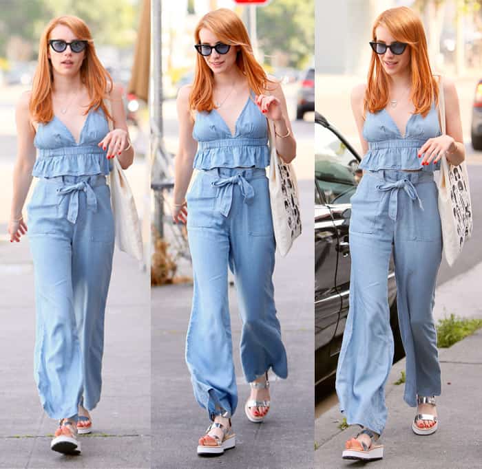 Emma Roberts is effortlessly stylish in a light blue chambray jumpsuit, paired with trendy platform sandals and chic sunglasses, perfect for a sunny day out