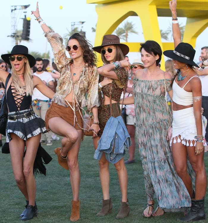 Alessandra Ambrosio leads her Coachella girl squad across the festival grounds, pairing relaxed layers and earthy tones with sturdy suede boots for effortless off-duty cool