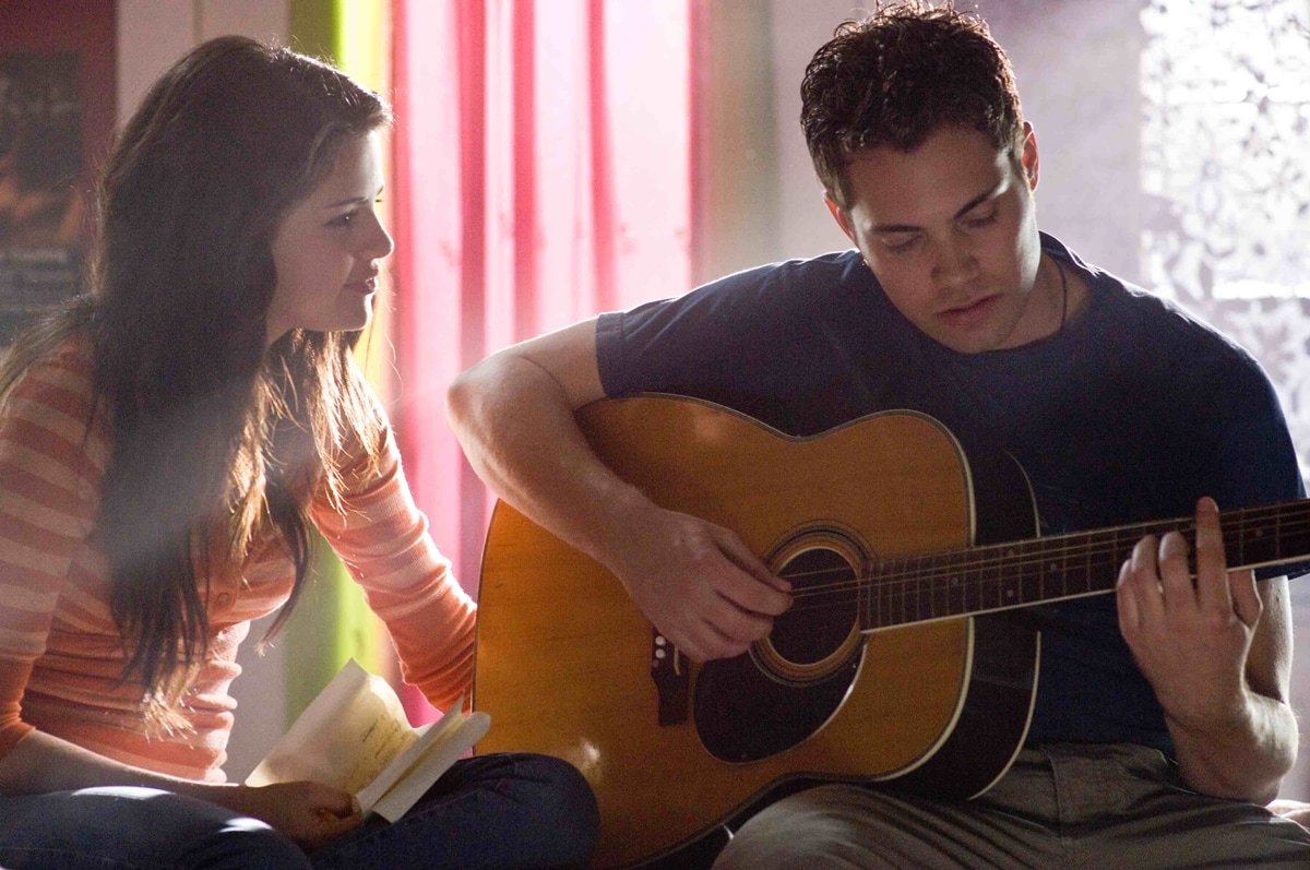 Selena Gomez shares a quiet moment with co-star Drew Seeley as their characters bond over music in Another Cinderella Story, highlighting the film’s modern, performance-driven twist on the classic fairy tale