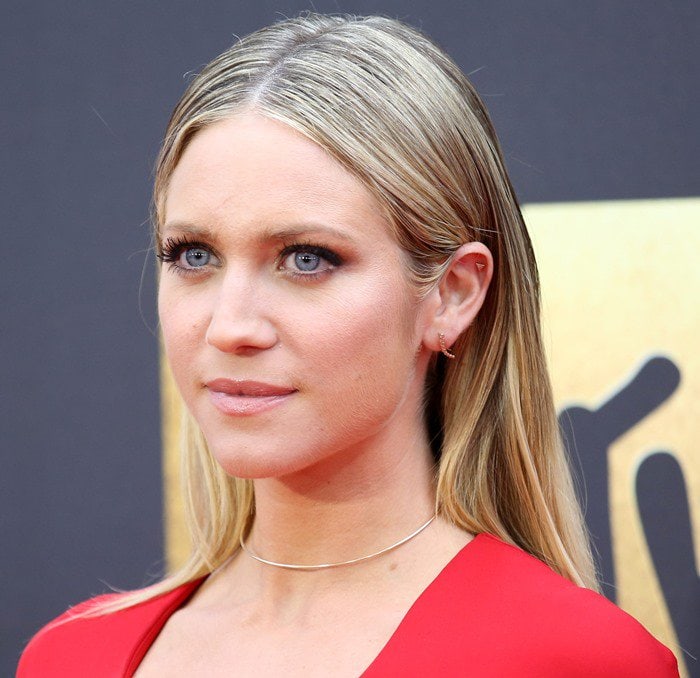 Brittany Snow keeps her beauty look sleek and minimal, center-parting her blonde hair and letting soft, neutral makeup complement the bold red dress