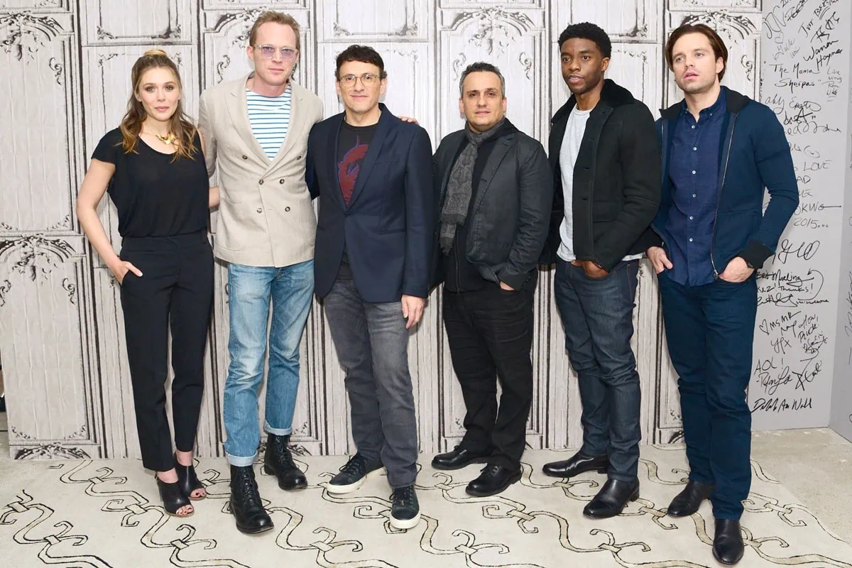 Elizabeth Olsen in a chic black jumpsuit and open-toe heels, Paul Bettany in cuffed jeans, a striped shirt, and double-breasted blazer, Anthony Russo, Joe Russo, Chadwick Boseman in a casual jacket and jeans, and Sebastian Stan in a navy shirt with dark jeans attend AOL Build Presents: Captain America: Civil War at AOL Studios in New York on May 4, 2016