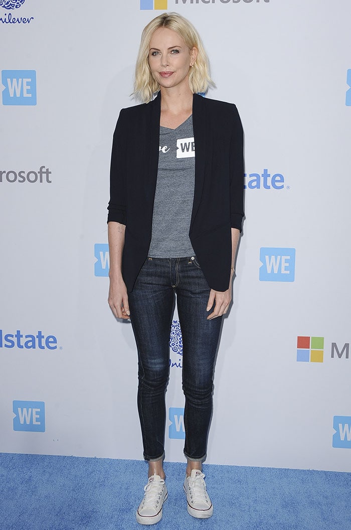 Charlize Theron kept things understated at WE Day California 2016, pairing a black blazer with a gray WE Day T-shirt, dark skinny jeans, and classic white Converse Chuck Taylor All Star sneakers