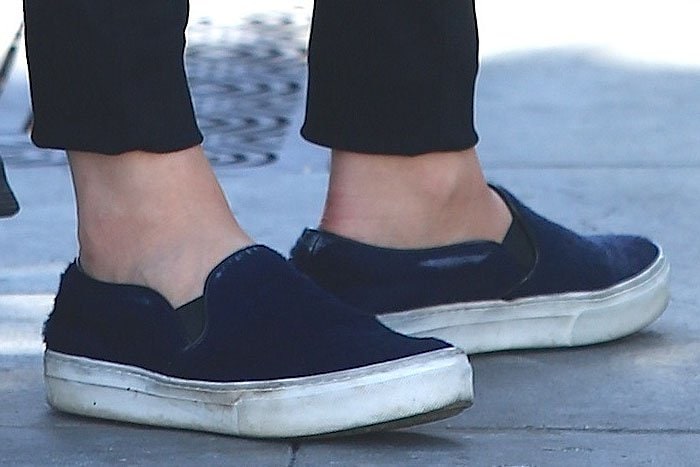 A close-up of Chloë Grace Moretz’s well-worn Céline blue pony-hair slip-on sneakers reveals the casual luxury of the designer pair, finished with thick white rubber soles