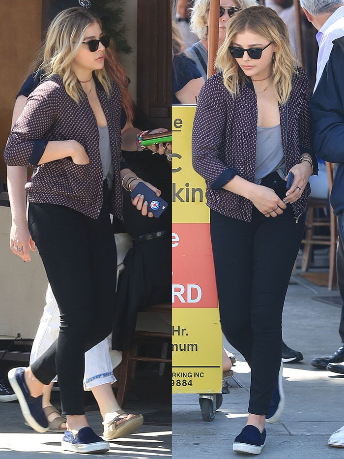 Chloë Grace Moretz steps out for lunch in Beverly Hills wearing a printed bomber jacket with black skinny jeans and navy Céline pony-hair slip-on sneakers
