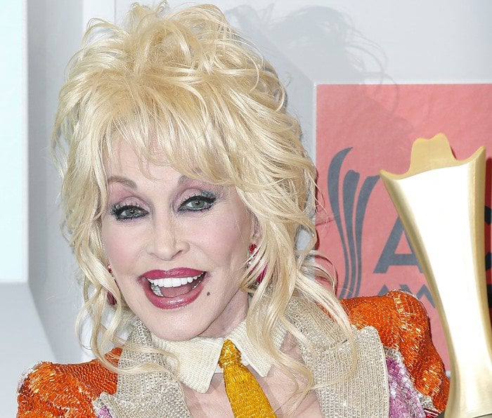 Dolly Parton flashes her signature smile in glamorous stage makeup at the 2016 Academy of Country Music Awards in Las Vegas