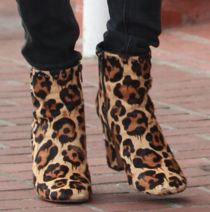 Emma Roberts steps out in bold Coach “Felicia” ankle boots crafted from leopard-print calf hair with polished dome studs and chunky block heels