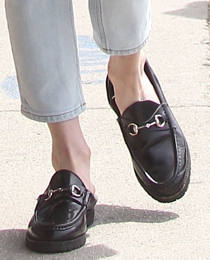 Emma Roberts steps out in glossy black Gucci Horsebit loafers, the sleek almond toe and iconic bit detail giving her cropped denim a quietly polished finish