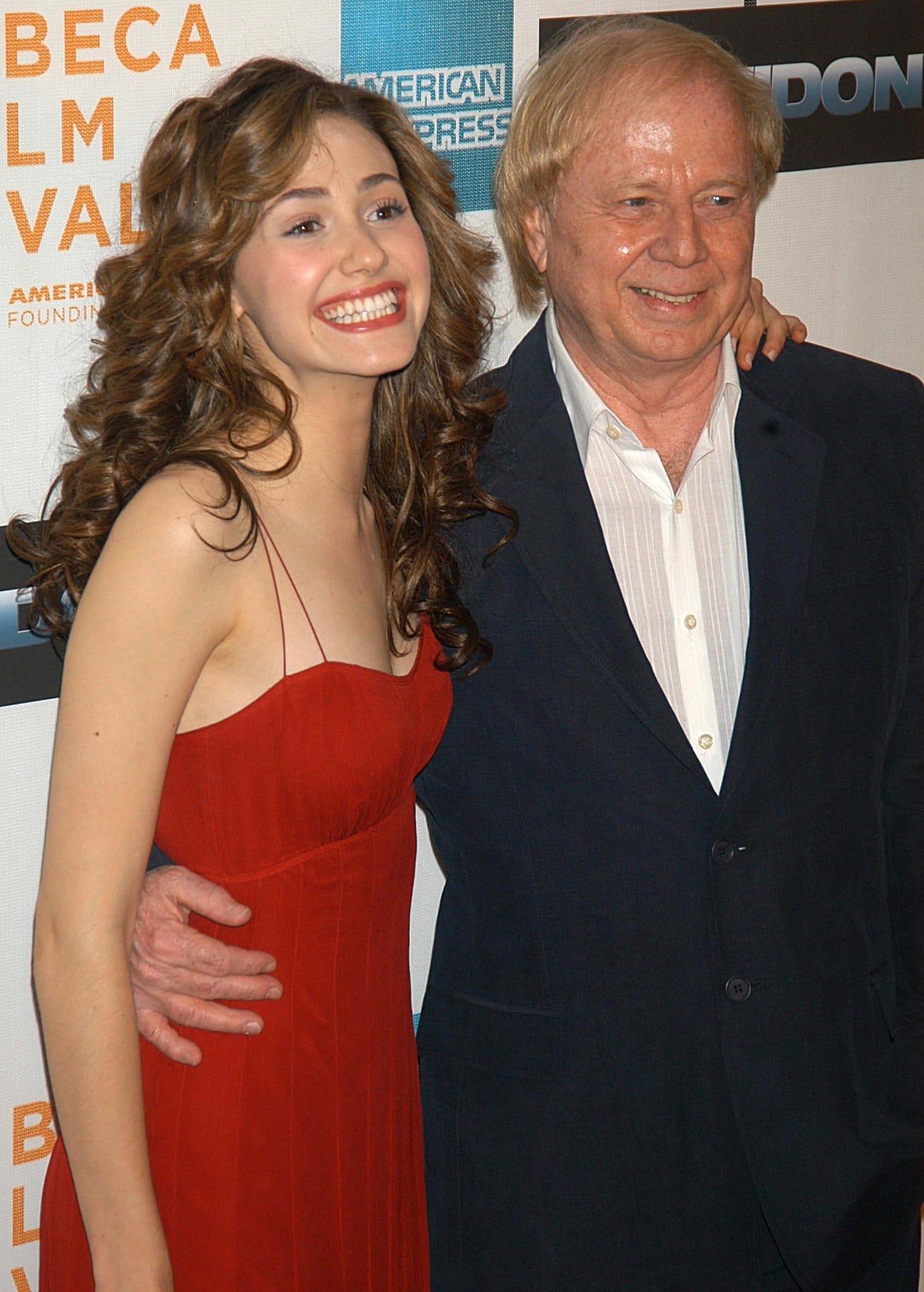 Emmy Rossum, radiant in a red spaghetti-strap dress, with director Wolfgang Petersen at the Poseidon screening during the 5th Annual Tribeca Film Festival