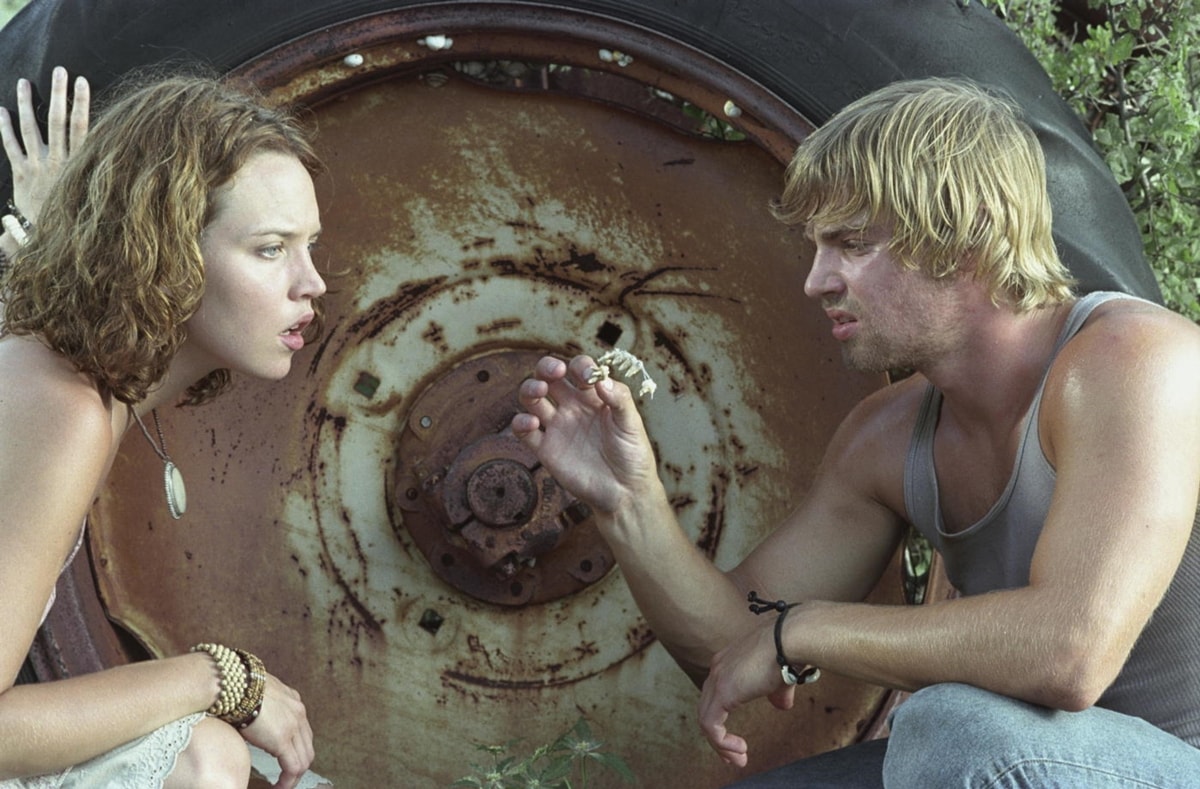 Erica Leerhsen channels a boho vibe in layered jewelry and a crochet-trimmed top, while Mike Vogel keeps it rugged in a gray tank and wrist cord in The Texas Chainsaw Massacre (2003)