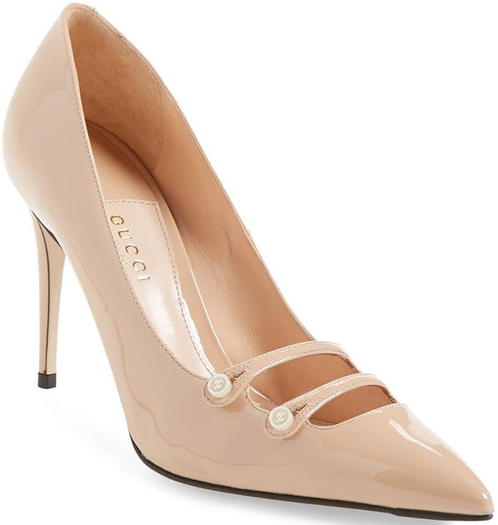 Nude Gucci “Aneta” double-strap patent pumps in glossy beige leather, originally retailing at $695, feature a sharply pointed toe and signature pearl-button vamp straps