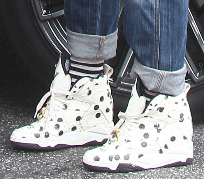 Gwen Stefani steps out in polka-dotted Melody Ehsani x Reebok wedge sneakers, the playful black-on-white print adding a bold twist to her cuffed-denim street style