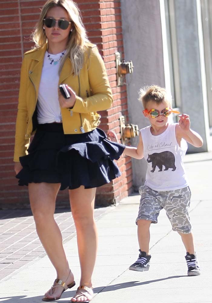 While spending the day with son Luca in Beverly Hills, Duff relied on flat designer sandals that balanced comfort with the polished feel of her statement jacket and ruffled skirt.