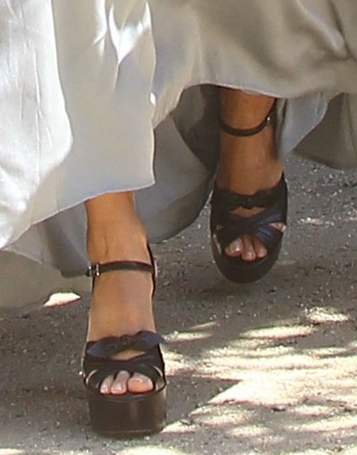 Close-up of the Saint Laurent “Candy” sandals reveals the chunky platform sole, cross-strap bow detail, and ankle strap that define the dramatic design