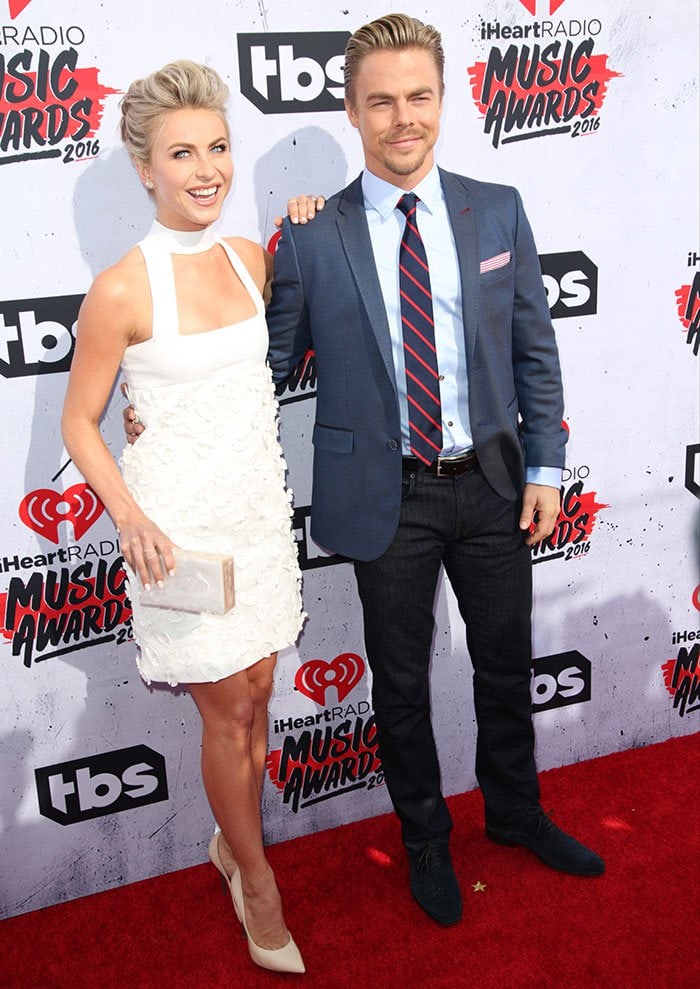 Julianne Hough posed with her brother, Derek Hough, whose tailored Ted Baker blazer, striped tie, and dark denim offered a classic contrast to her modern monochrome red-carpet look