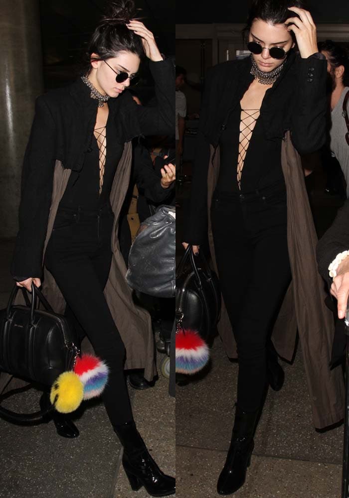 Kendall Jenner sharpens her all-black, lace-up bodysuit look with glossy patent ankle boots that add structure and a polished, after-dark edge
