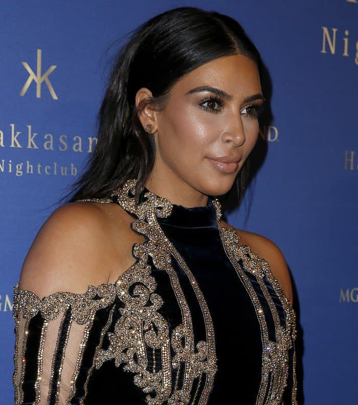 The intricate gold embroidery of Kim’s Balmain dress framed her shoulders and neckline, adding opulence to her velvet bodice