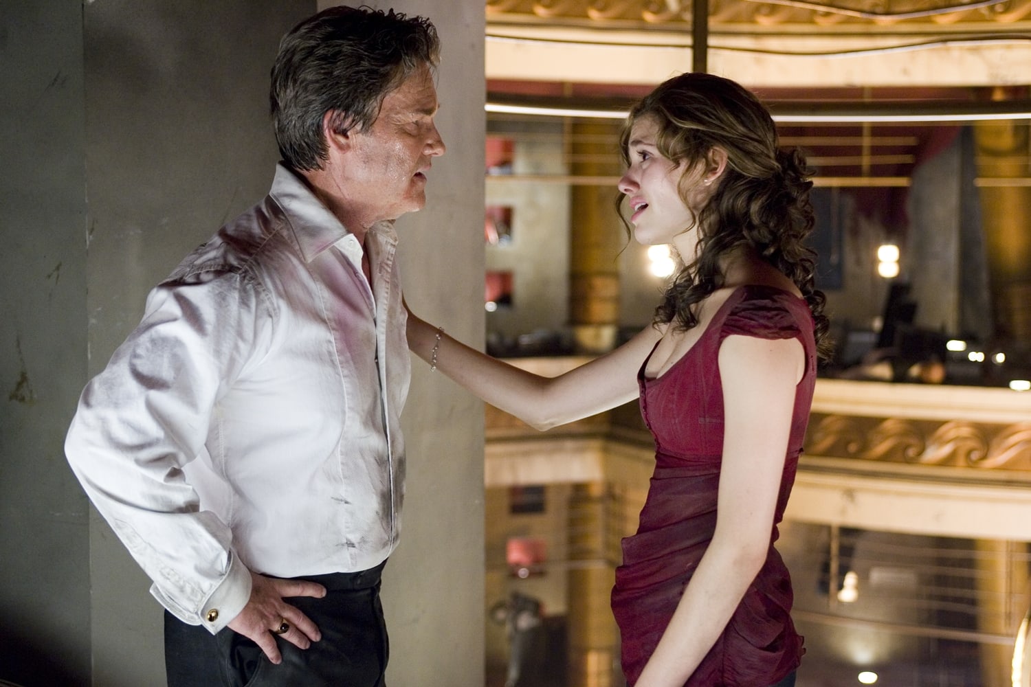 Kurt Russell as Robert Ramsey with Emmy Rossum in her signature red sleeveless blouse and trousers as Jennifer Ramsey in Poseidon