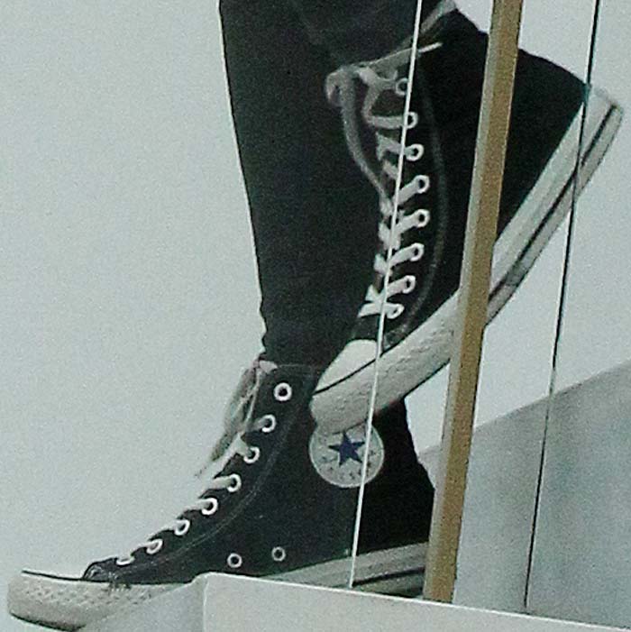 A close-up of her well-worn Chuck Taylor All Stars proves their timeless appeal in off-duty dressing