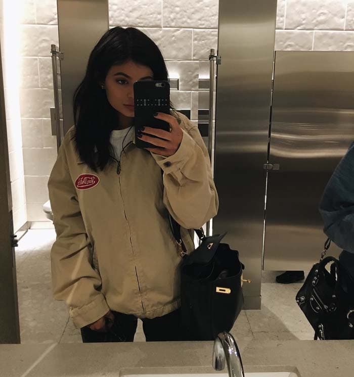 Kylie later shared a mirror selfie from inside Restoration Hardware, accessorizing her sneakers-and-jacket look with a luxe Hermès tote