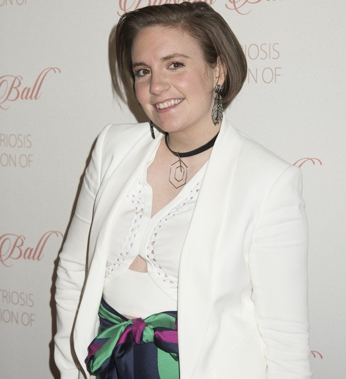 Lena Dunham in a white blazer with a matching lattice cut-out crop top