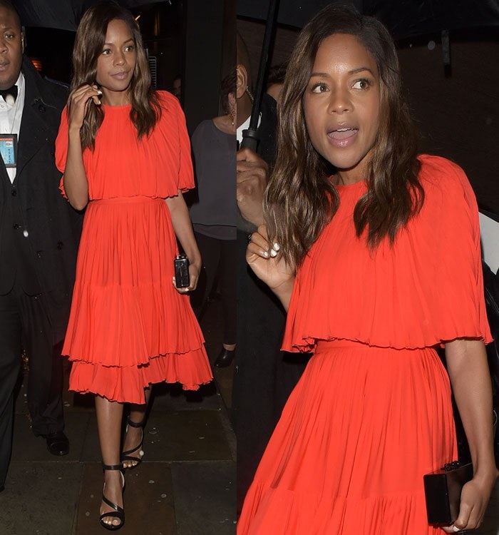 Naomie Harris brightens the night in a vivid orange Kate Spade tiered dress, styled with glossy black Prada asymmetric sandals and a sleek Edie Parker clutch at the Restaurant Ours launch in London