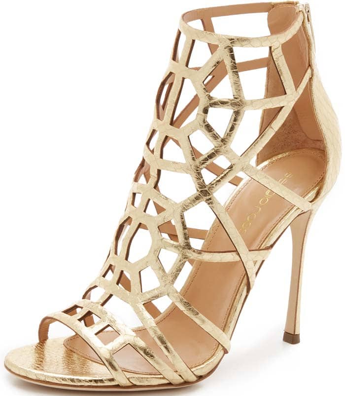 Gold Sergio Rossi “Puzzle” metallic elaphe sandals showcase an intricate cage of interlocking straps in glossy snakeskin, sculpting the foot with a high-shine, architectural finish atop a slim stiletto heel (original retail price: $1,195)