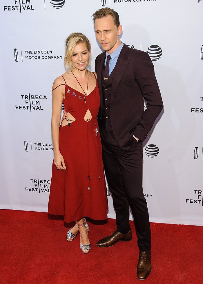 Sienna Miller poses with Tom Hiddleston in his Dolce Gabbana suit