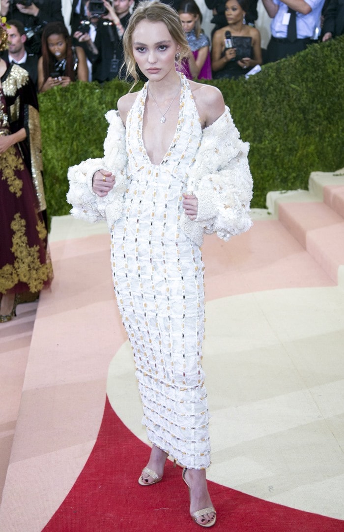 Lily-Rose Depp in a plunging white gown paired with an edgy oversized bolero jacket from the Chanel Spring/Summer 2016 Haute Couture collection