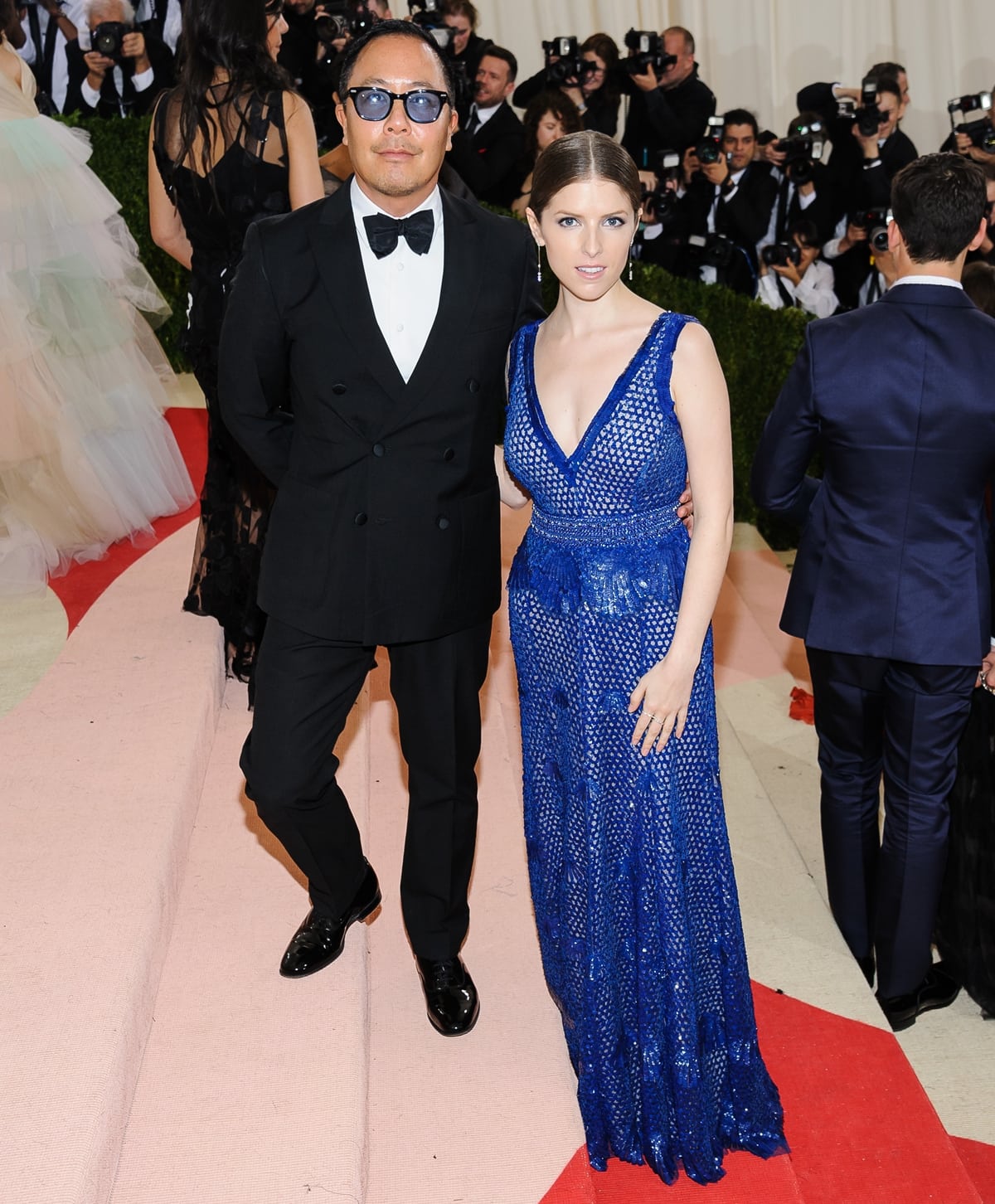 Anna Kendrick stuns in a custom blue Derek Lam embellished gown, perfectly complementing the designer's sophisticated black-tie look at the 2016 Met Gala