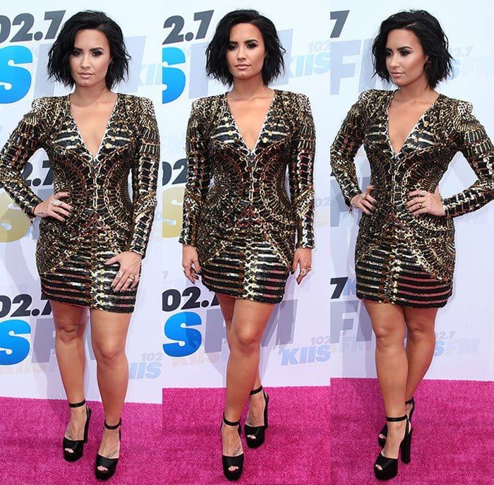Demi Lovato strikes a powerful pose in a plunging, animal-print Balmain mini dress and sky-high Giuseppe Zanotti platforms that added drama to her Wango Tango pink carpet appearance