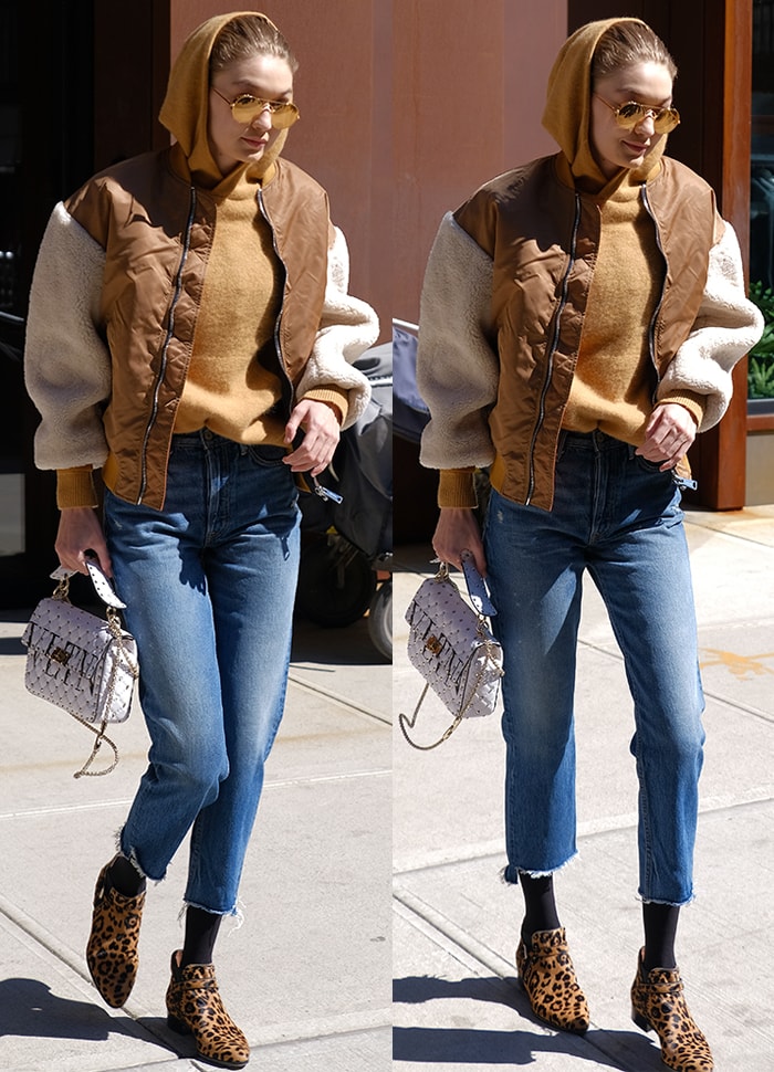 Gigi Hadid pairs cropped straight-leg jeans with a camel sweater and quilted bomber jacket, finishing the layered street look with Tabitha Simmons “Gigi” leopard-print ankle boots