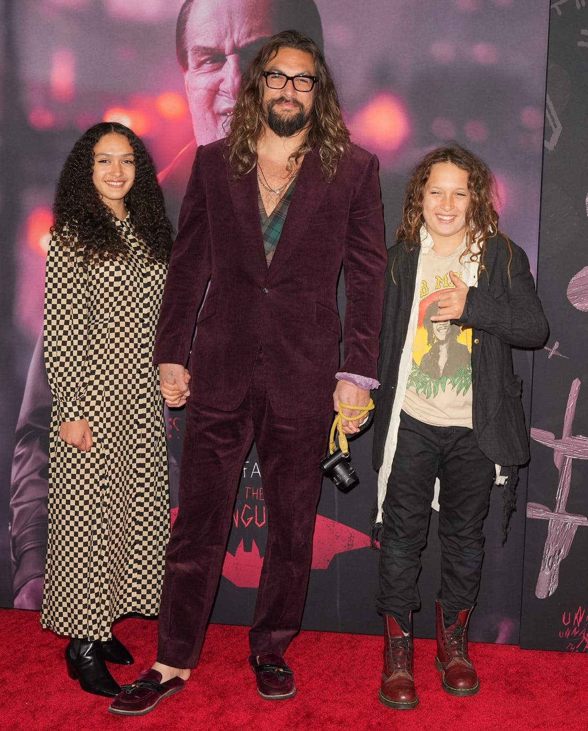 Jason Momoa wears burgundy velvet loafers while his daughter Lola sports black pointed-toe boots and son Nakoa-Wolf rocks classic red Dr. Martens combat boots at The Batman premiere