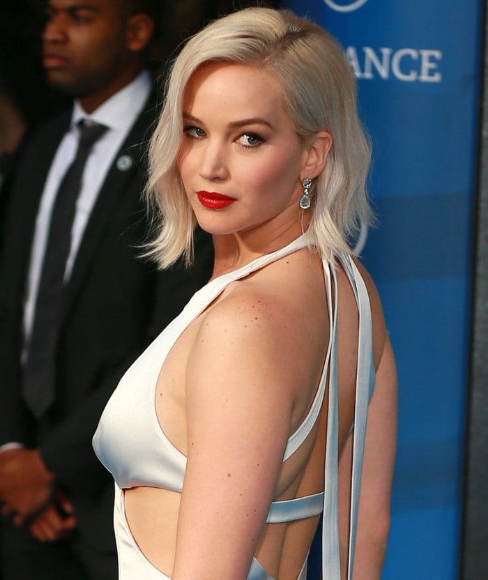 Jennifer Lawrence pairs her platinum blonde bob with classic red lipstick and sparkling diamond earrings