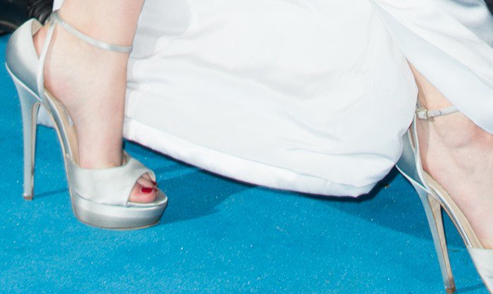 Jennifer Lawrence showcases Jimmy Choo's crystal-embellished 'Pearl' platform sandals beneath her pale silver Christian Dior gown