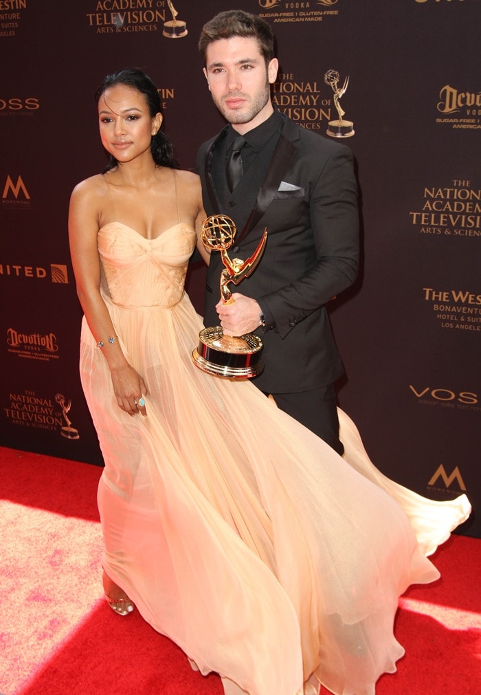 Karrueche Tran poses with Kristos Andrews and the Emmy they received for "The Bay"