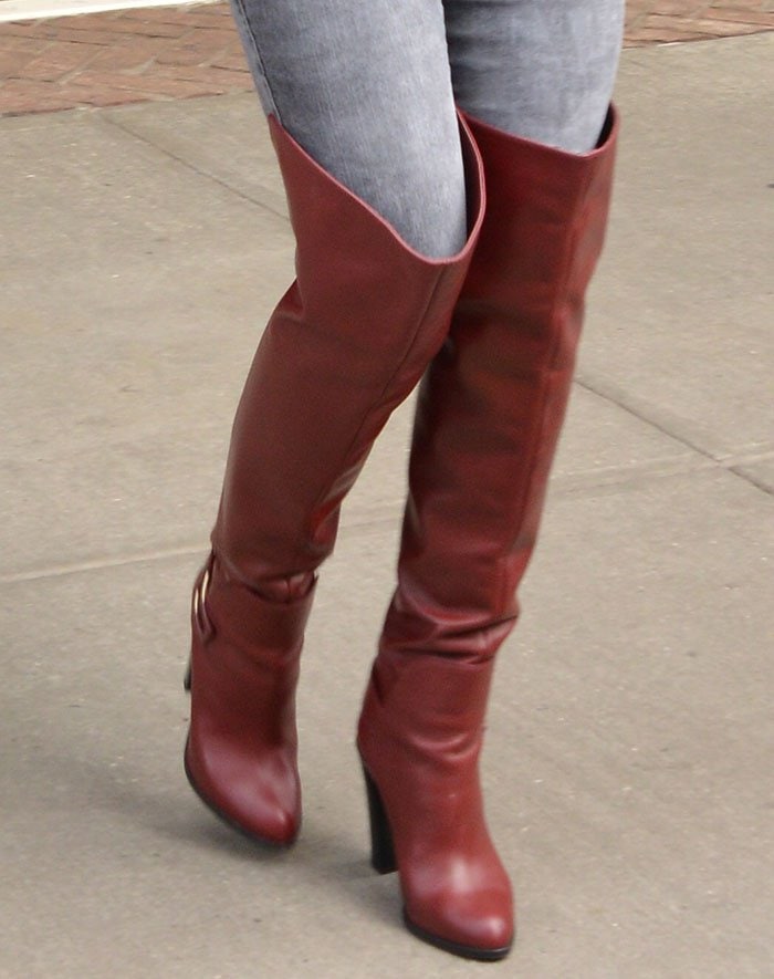Kate Hudson's boots feature a split at the back, buckled harness straps, and chunky heels