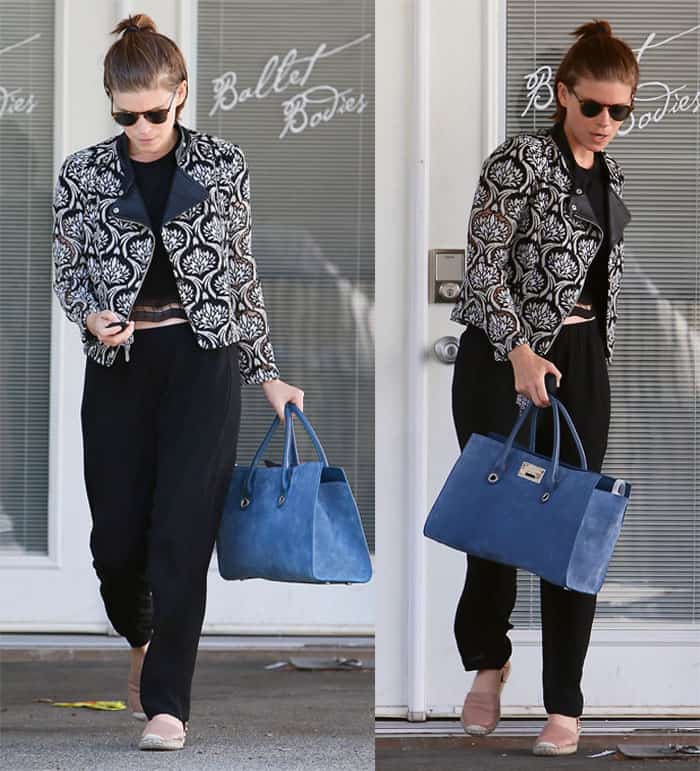 Kate Mara leaving Ballet Bodies in West Hollywood on May 26, 2016, wearing a Yigal Azrouël embroidered lace moto jacket, black sweatpants, a cropped top, and carrying a Jimmy Choo Riley tote bag