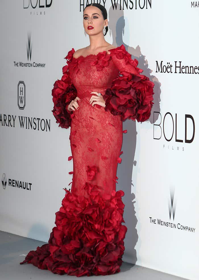 Katy Perry wore a dramatic Marchesa Fall 2016 gown crafted from ombré Chantilly lace, with sculpted floral appliqués blooming across the sleeves and fishtail hem, paired with Giuseppe Zanotti "Betty" platform sandals for added height and balance
